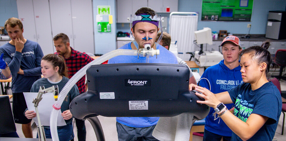 Students practice using a metabolic cart, analyzing a fellow student’s oxygen consumption whilst he exercises.