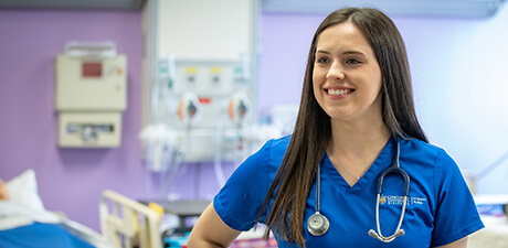 A nursing student practicing in one of our simulation hospital rooms.