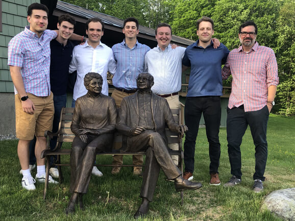 Group photo behind bronze statue of CAPITAF founders