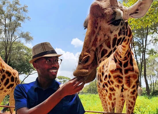 Fulbright student with a Giraffe