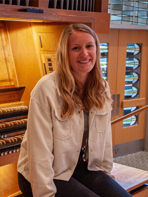 Student sitting on organ bench